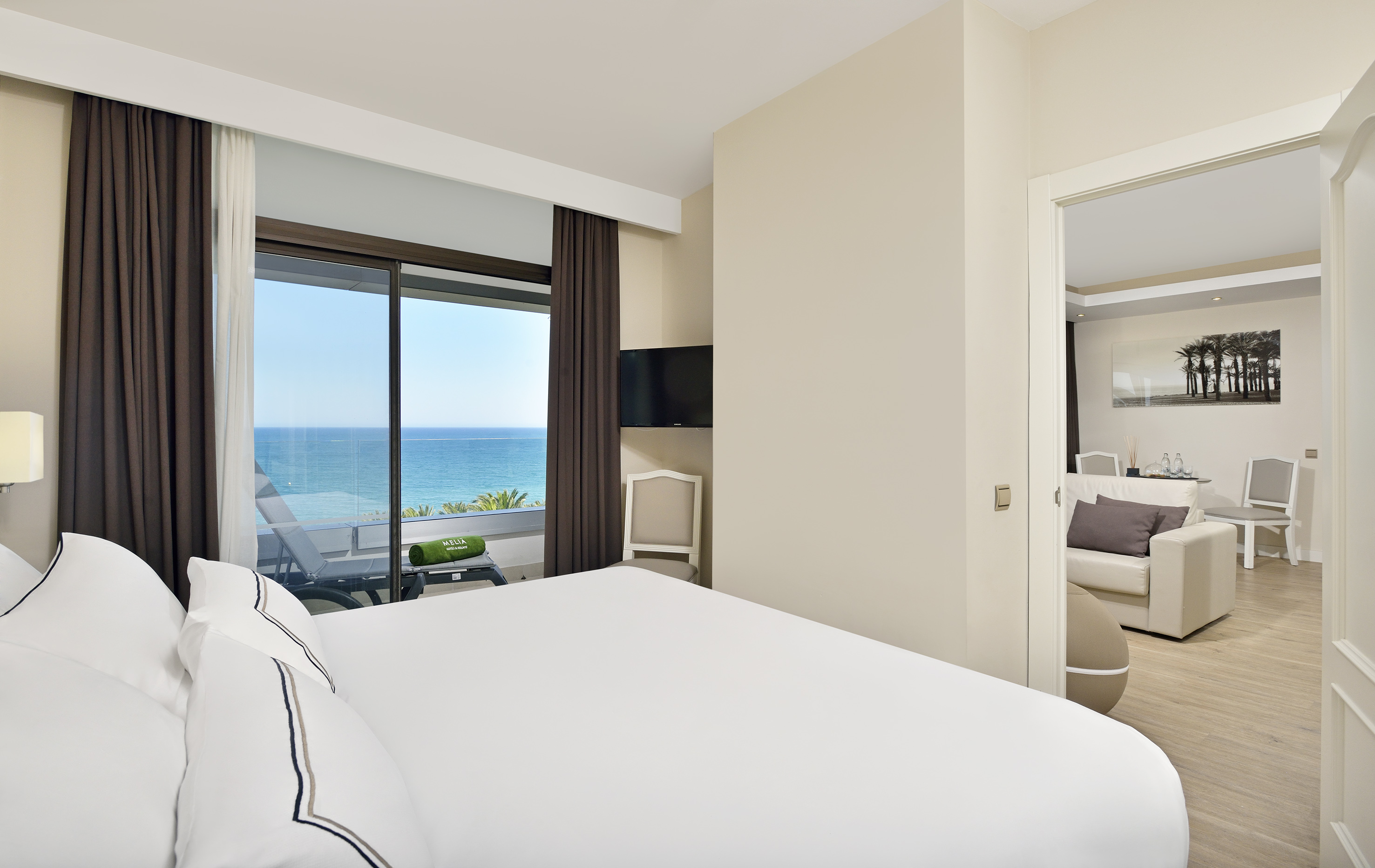 a bedroom with a view of the ocean