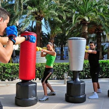 a group of people punching bags outside