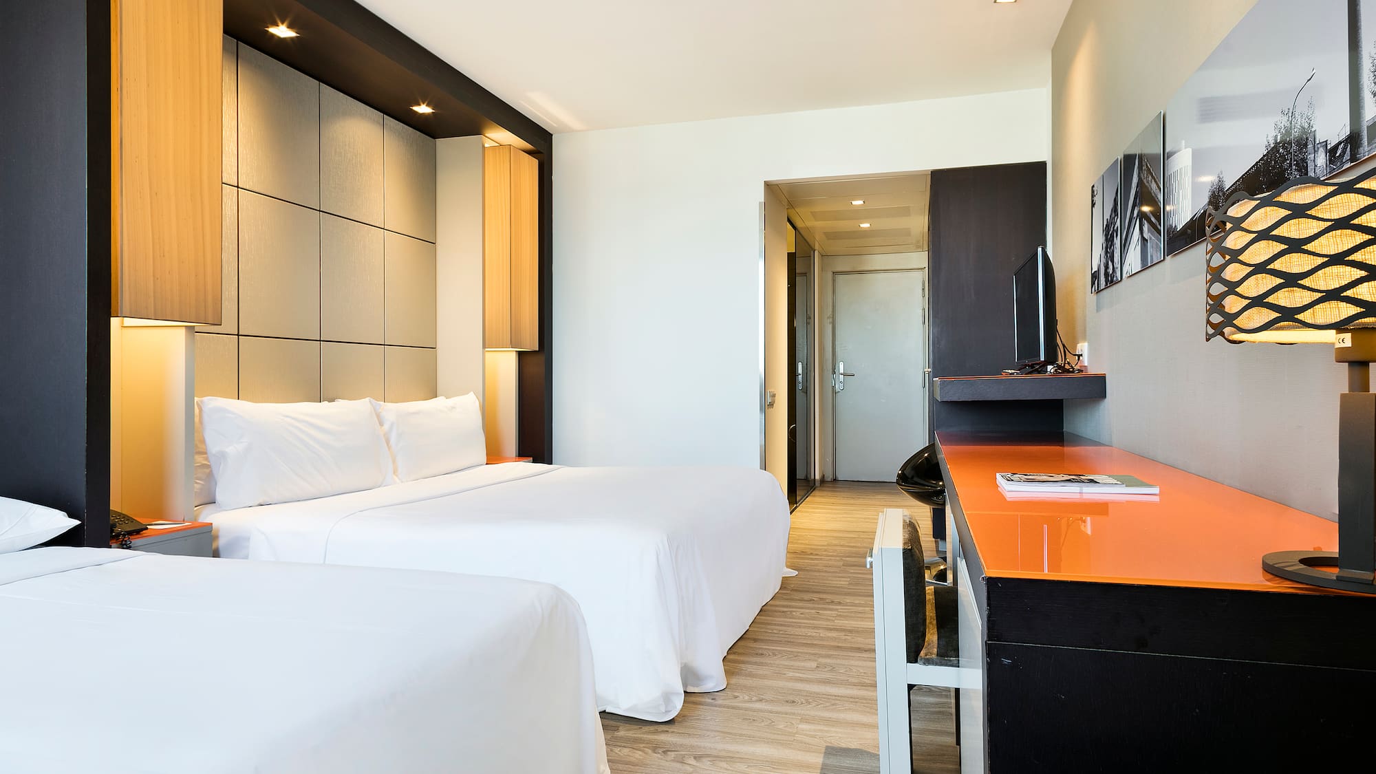 a room with two beds and a desk