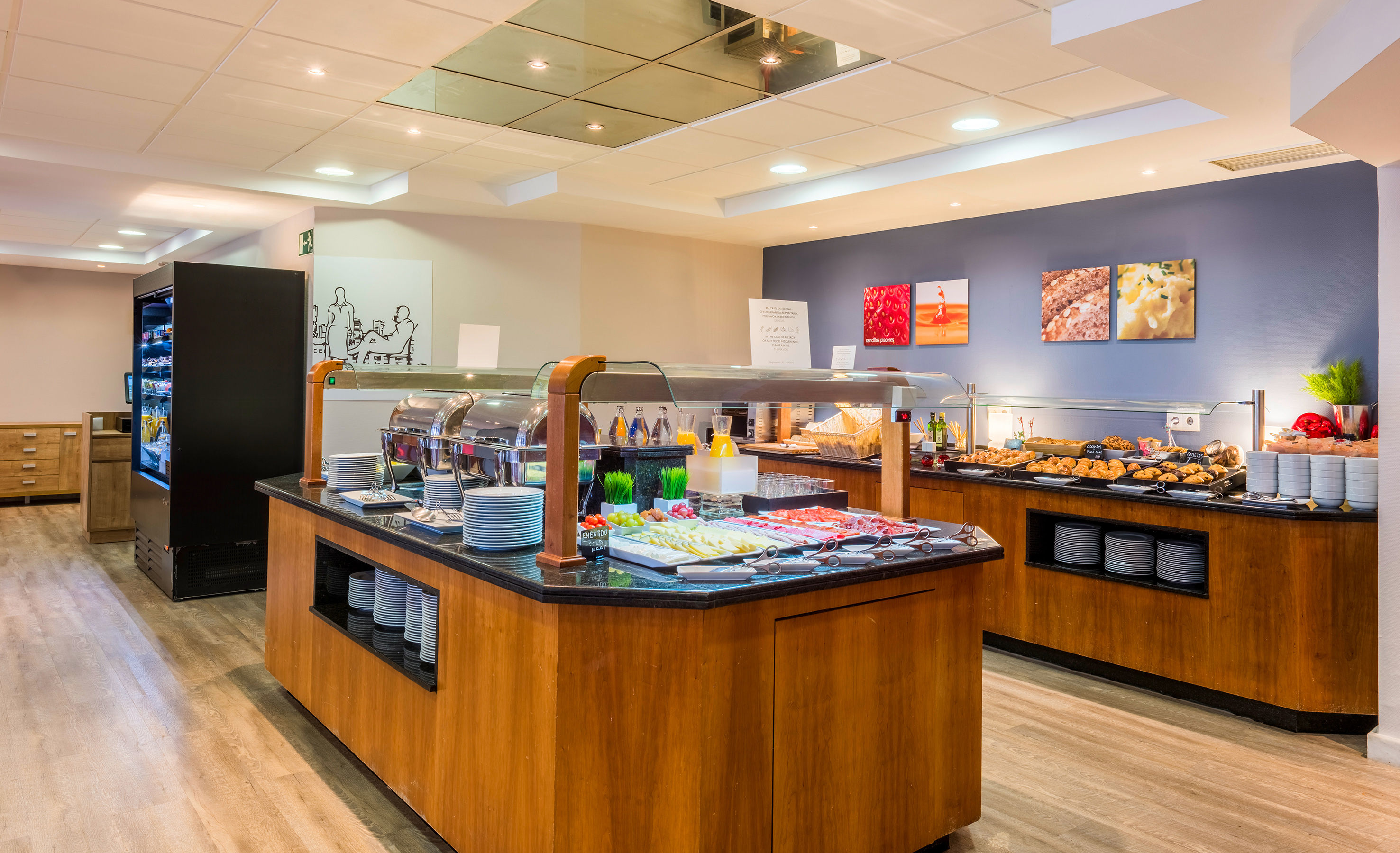 Hotel breakfast buffet with hot and cold food, pastries, and drinks.