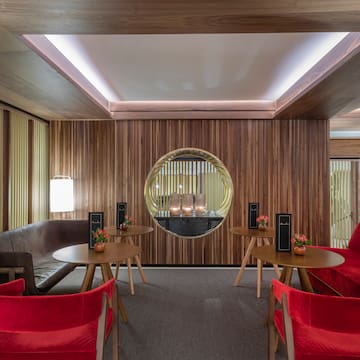 a room with red chairs and tables