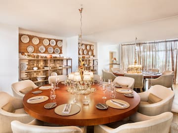 a room with a round table and chairs
