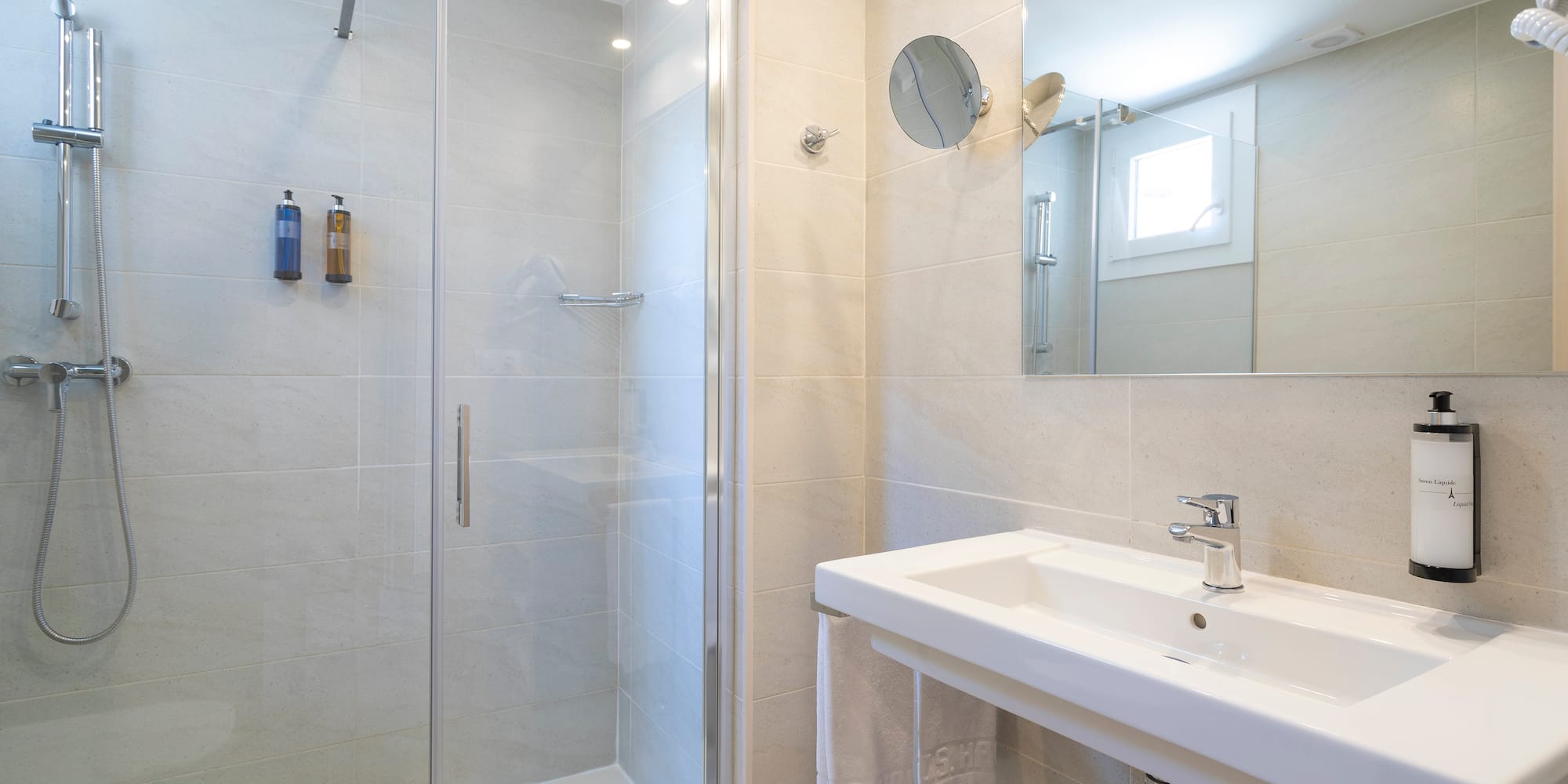 a bathroom with a shower and sink