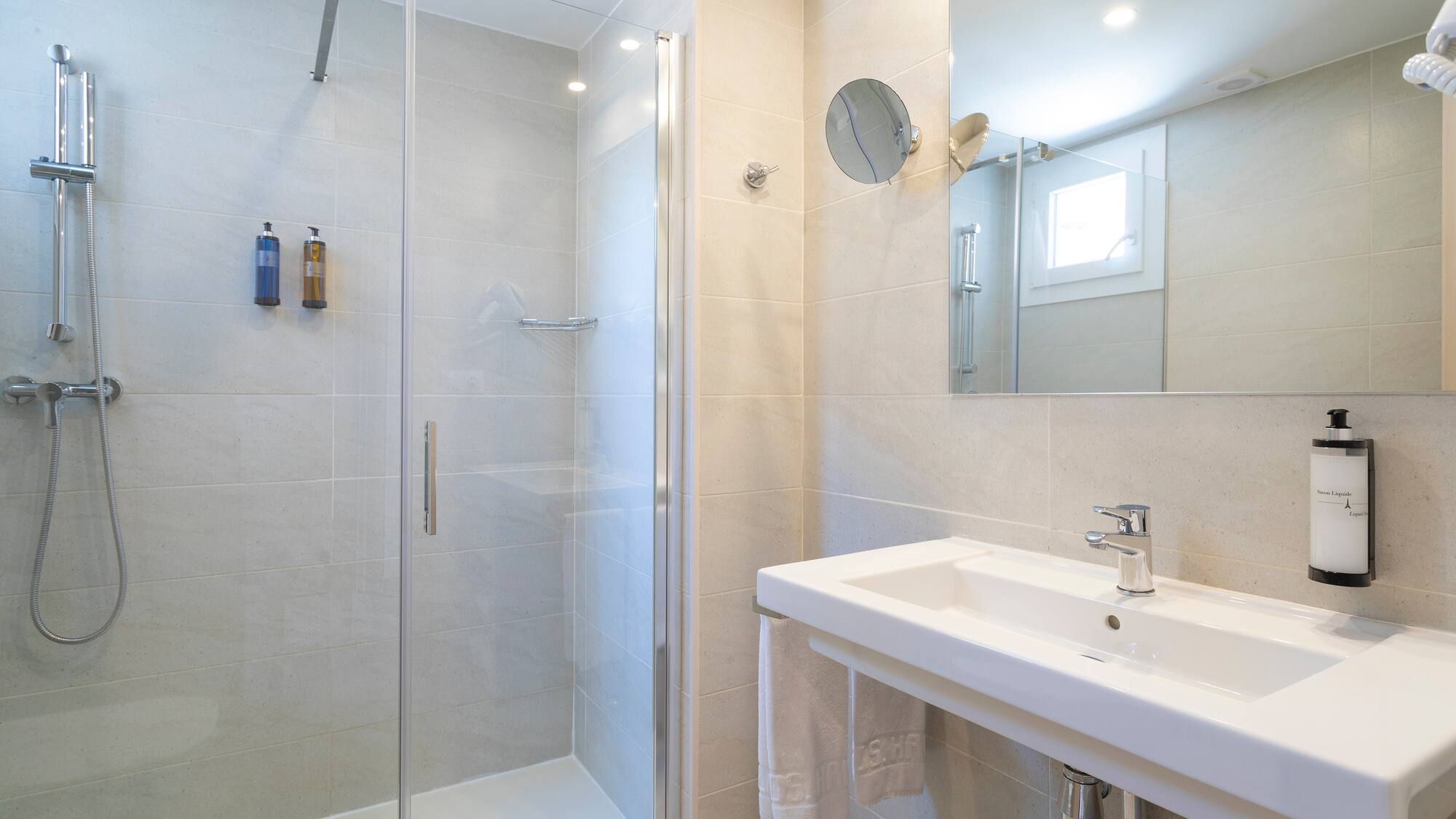 a bathroom with a shower and sink