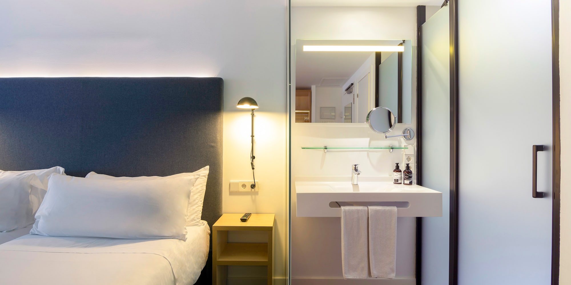 a bathroom with a bed and sink