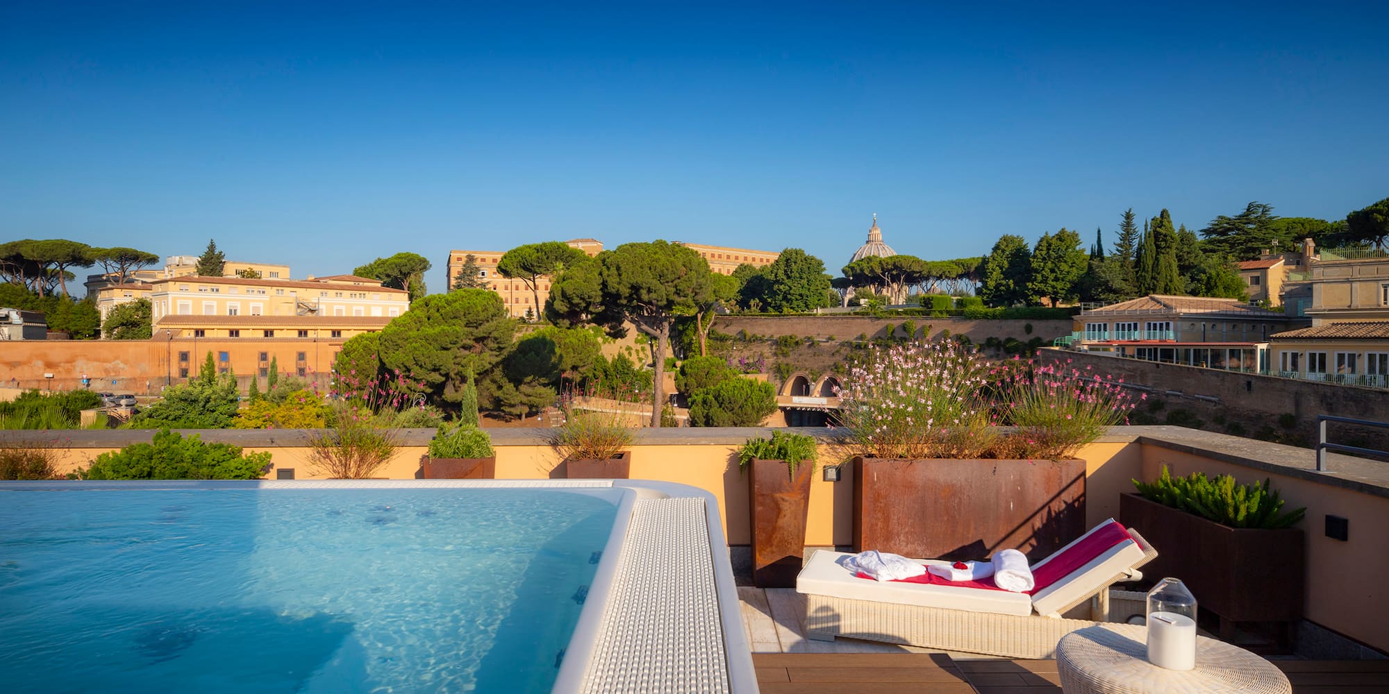 a pool on a rooftop with a view of a city and buildings