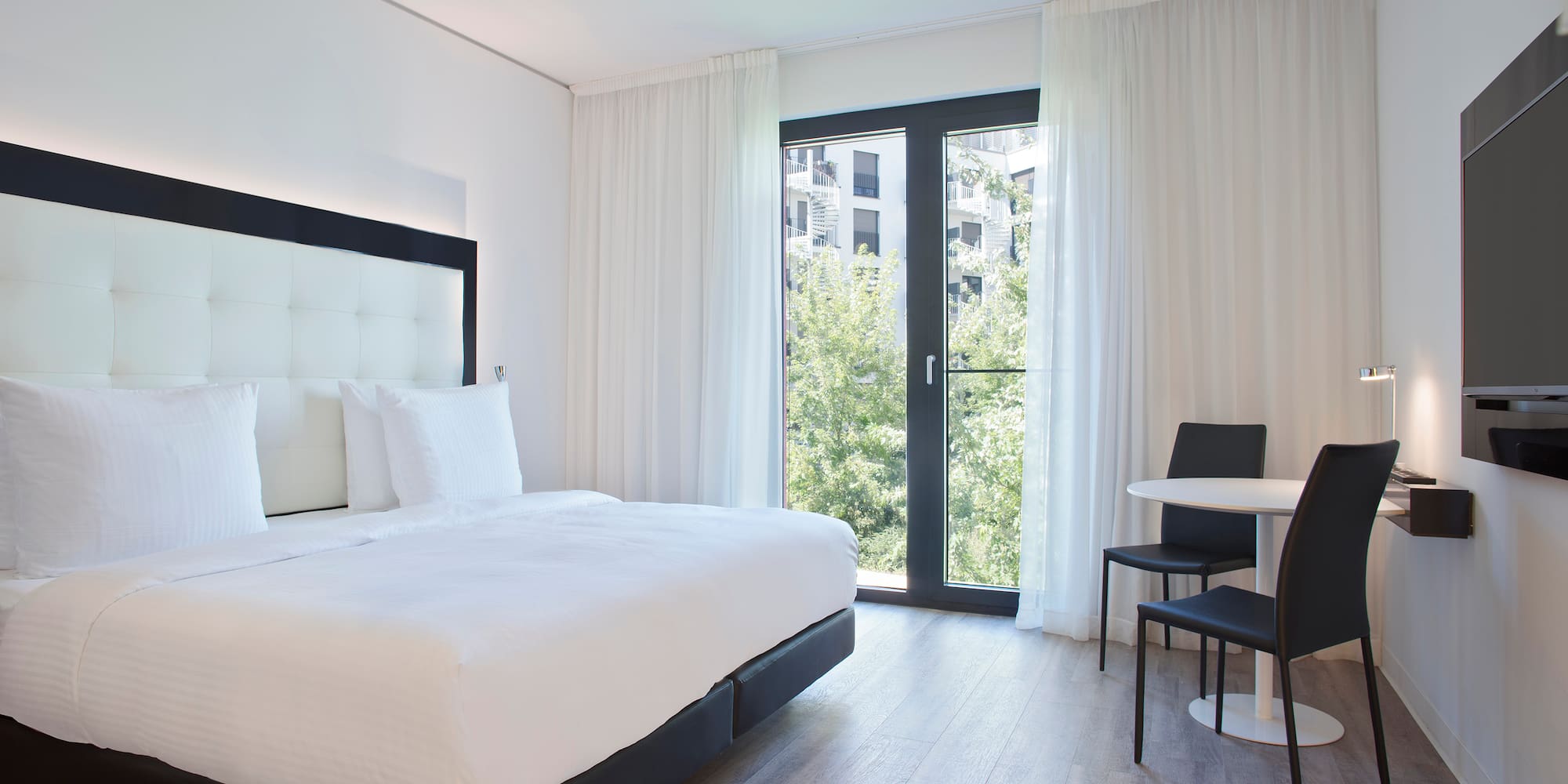 a bedroom with a bed and a table