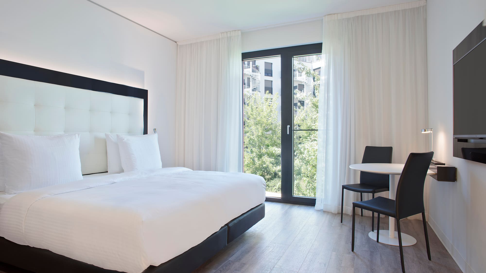 a bedroom with a bed and a table