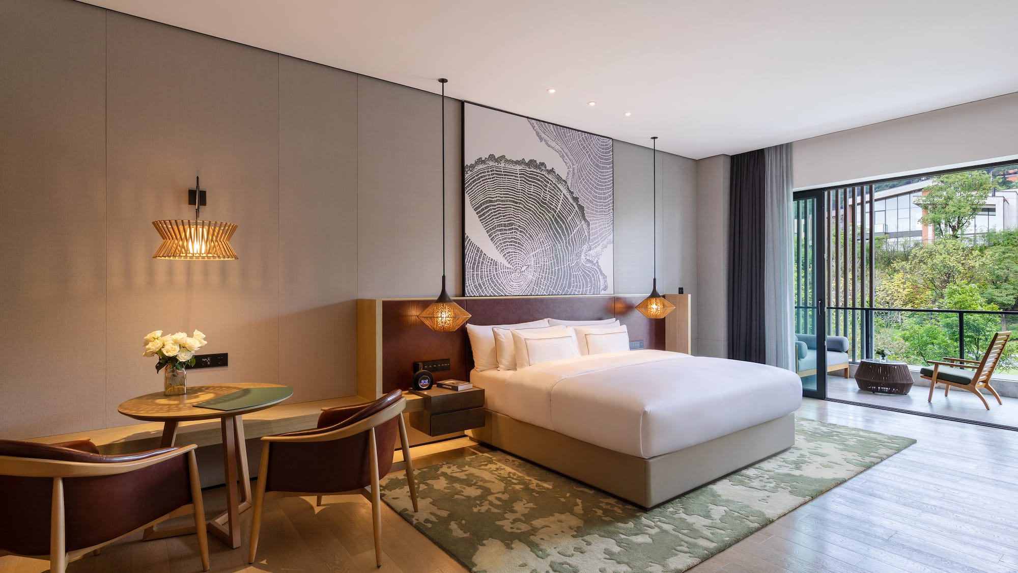 a room with a bed and chairs