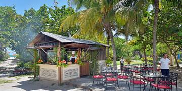 a man standing behind a bar