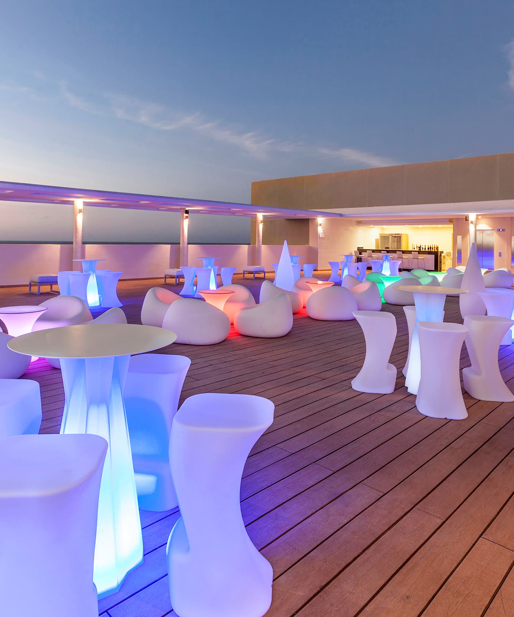 a group of tables and chairs on a deck