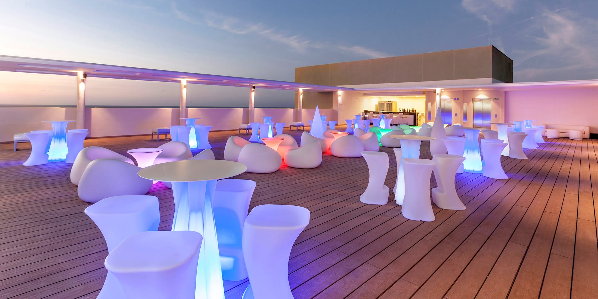 a group of tables and chairs on a deck