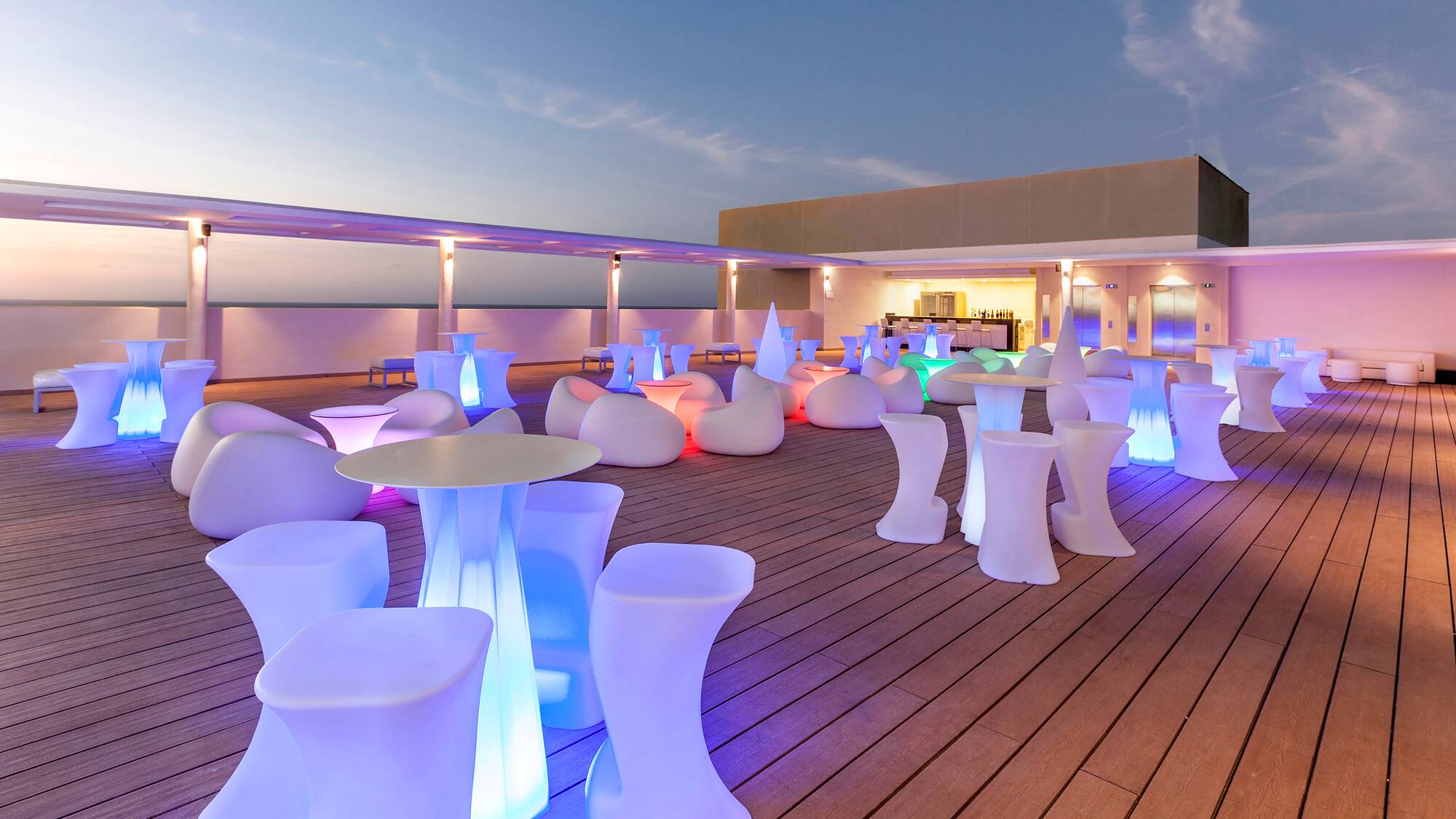 a group of tables and chairs on a deck