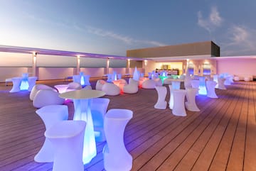 a group of tables and chairs on a deck