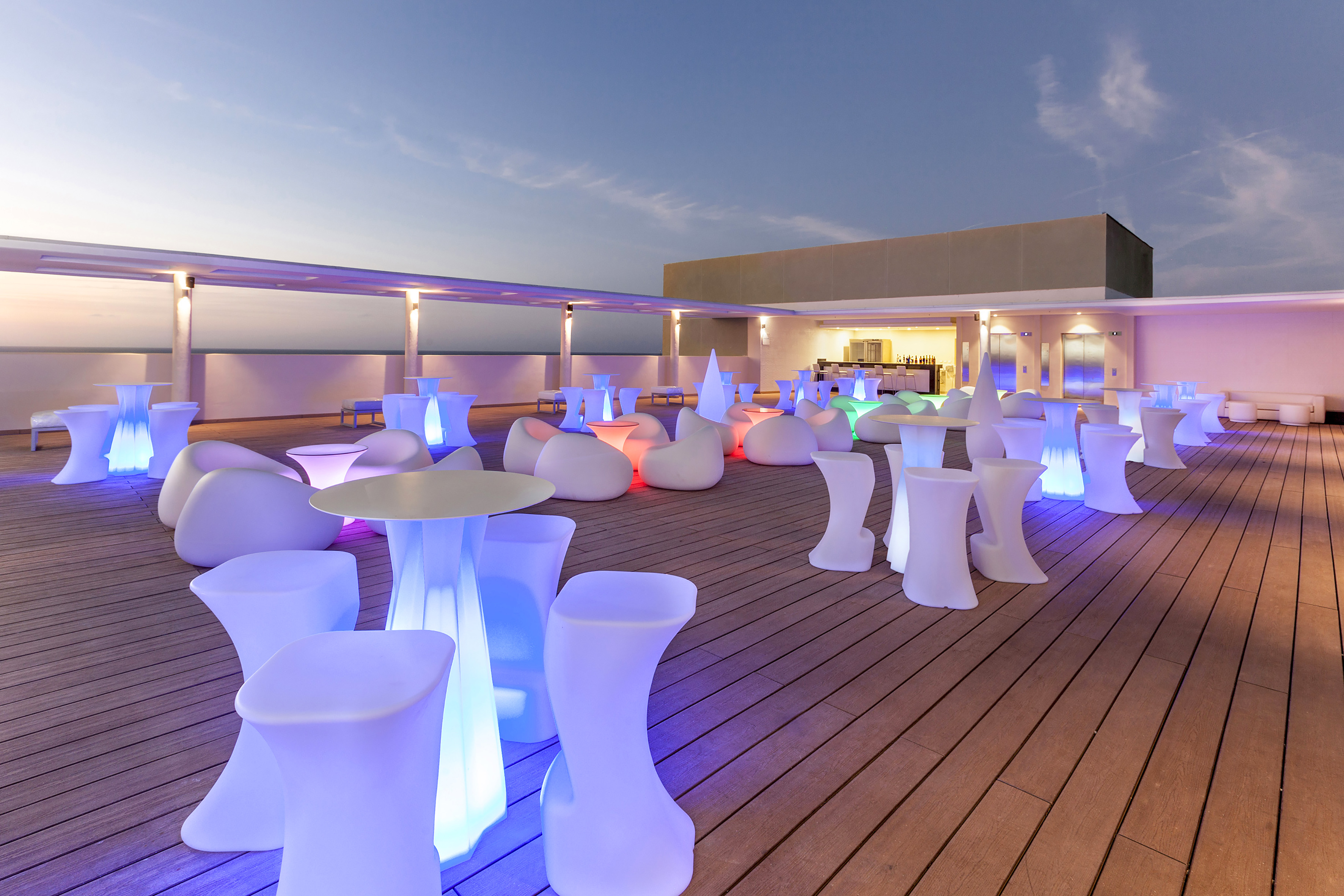 a group of tables and chairs on a deck