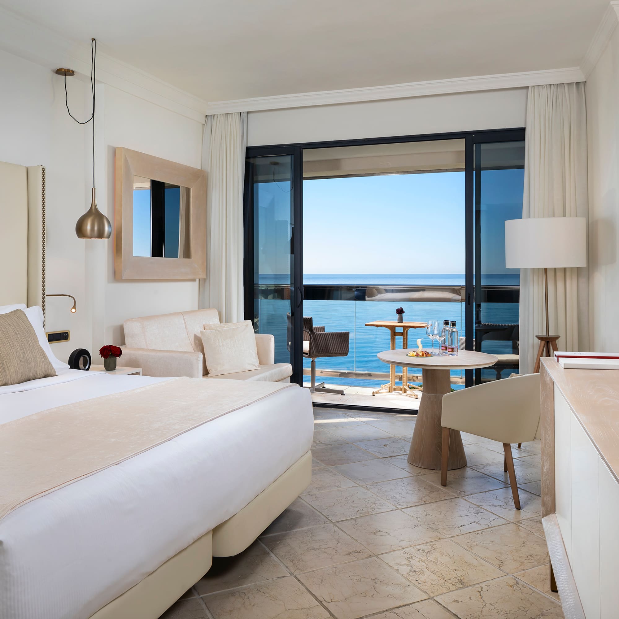 a room with a bed and a table and chairs