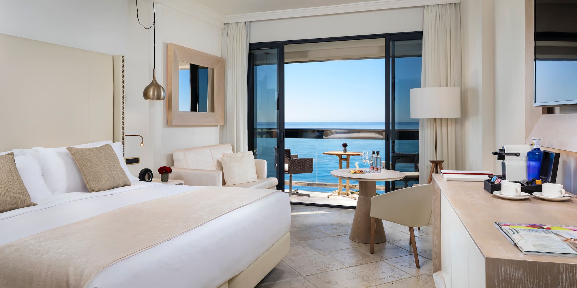 a room with a bed and a table and chairs