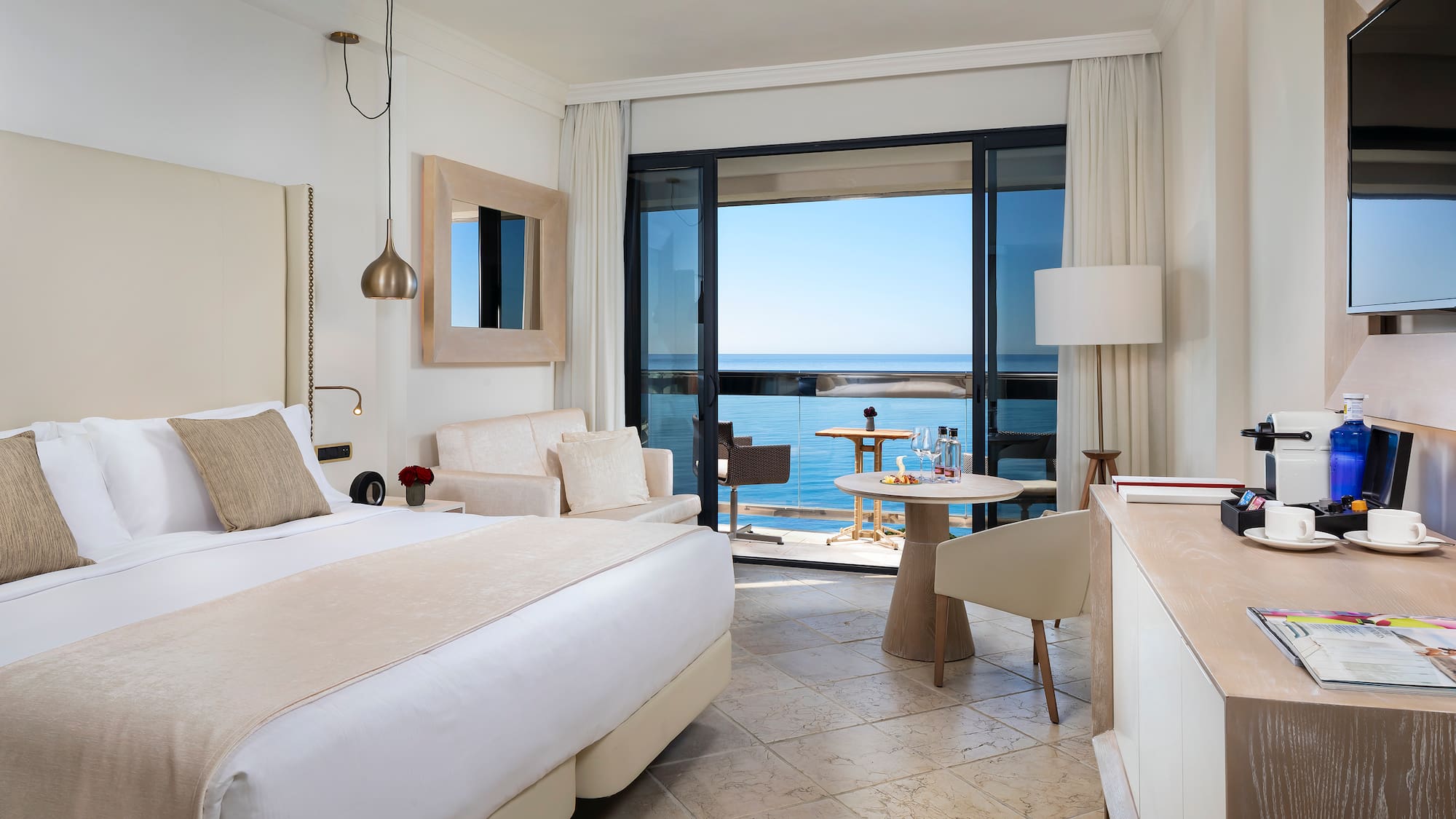 a room with a bed and a table and chairs