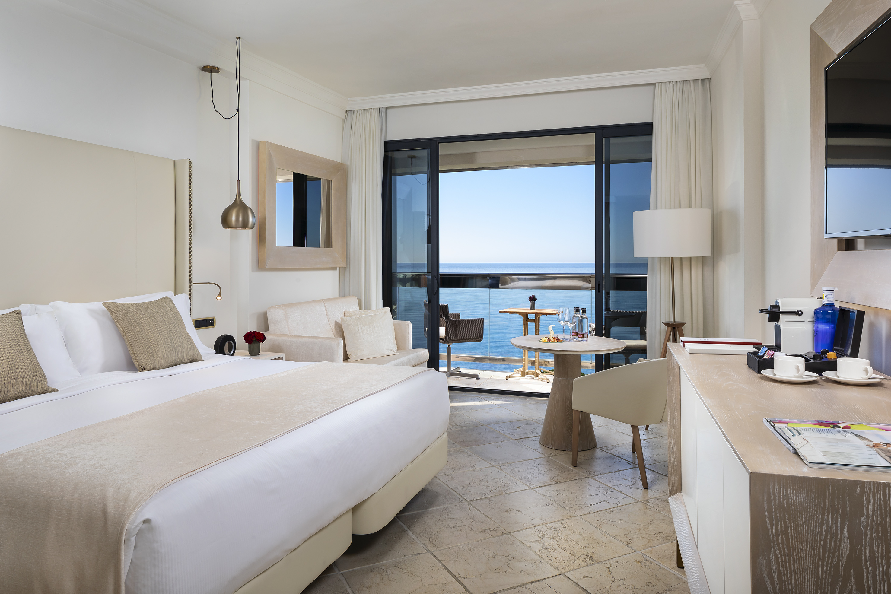 a room with a bed and a table and chairs