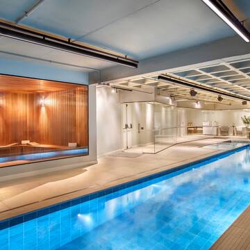 a indoor swimming pool with a large glass wall