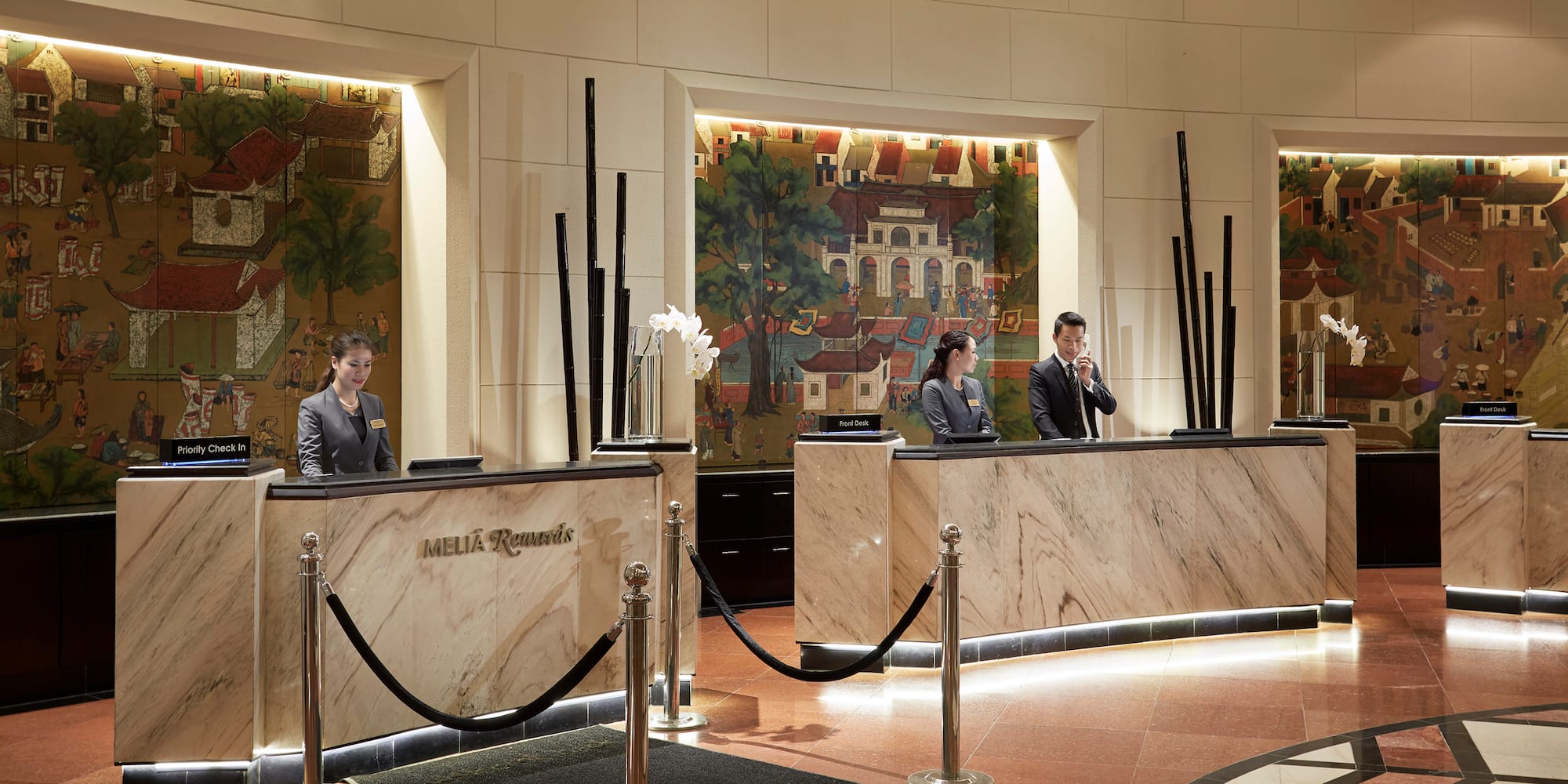 a group of people standing at a reception desk