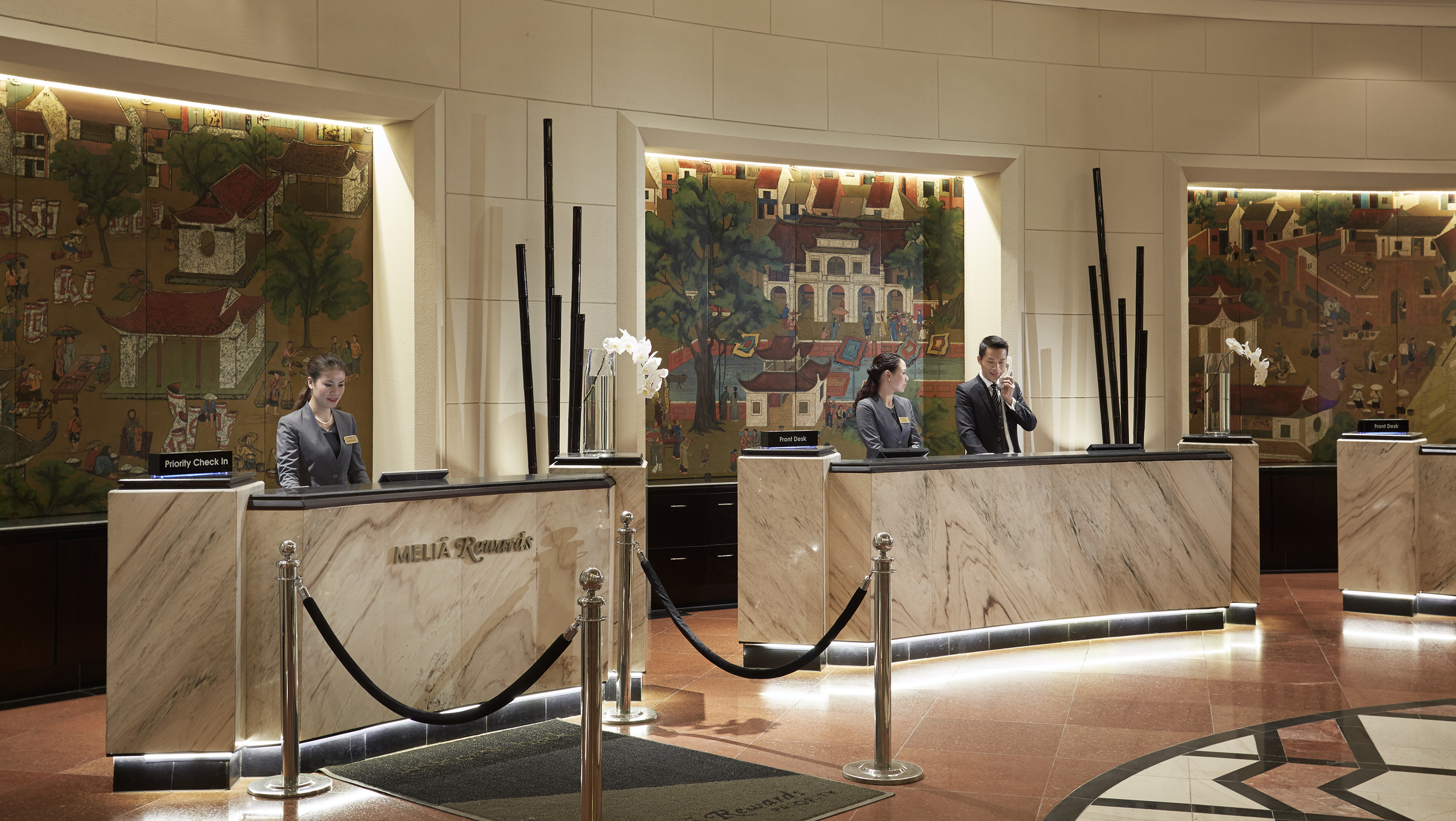 a group of people standing at a reception desk