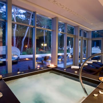 a hot tub inside a room with large windows
