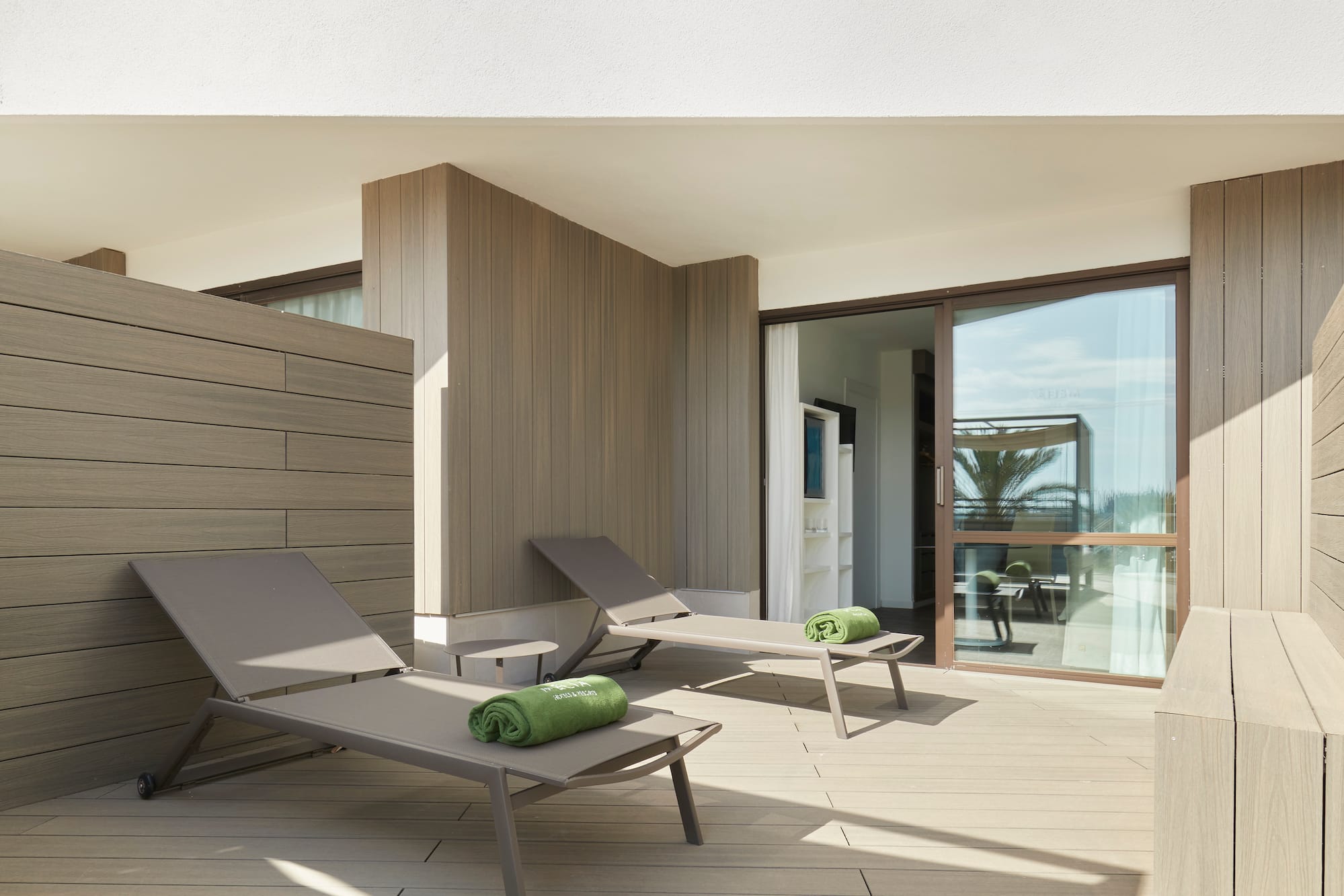 a deck with lounge chairs and towels on it