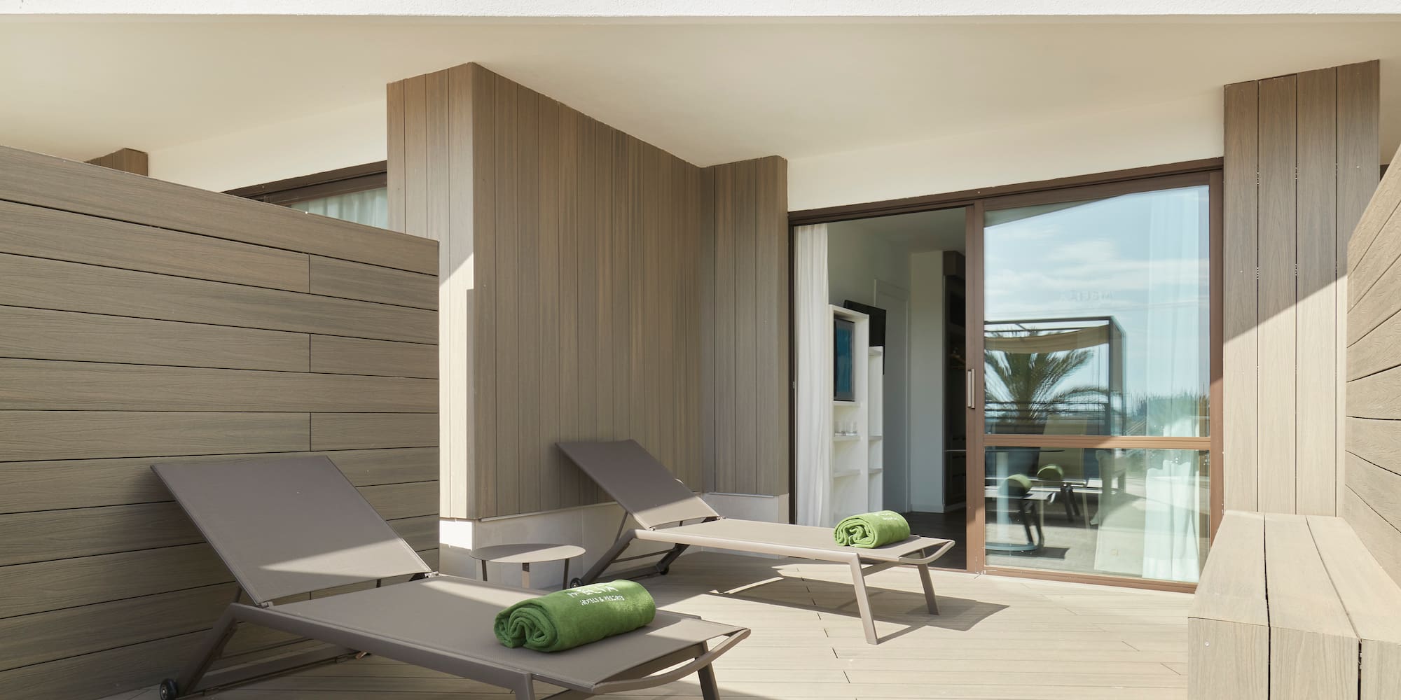 a deck with lounge chairs and towels on it