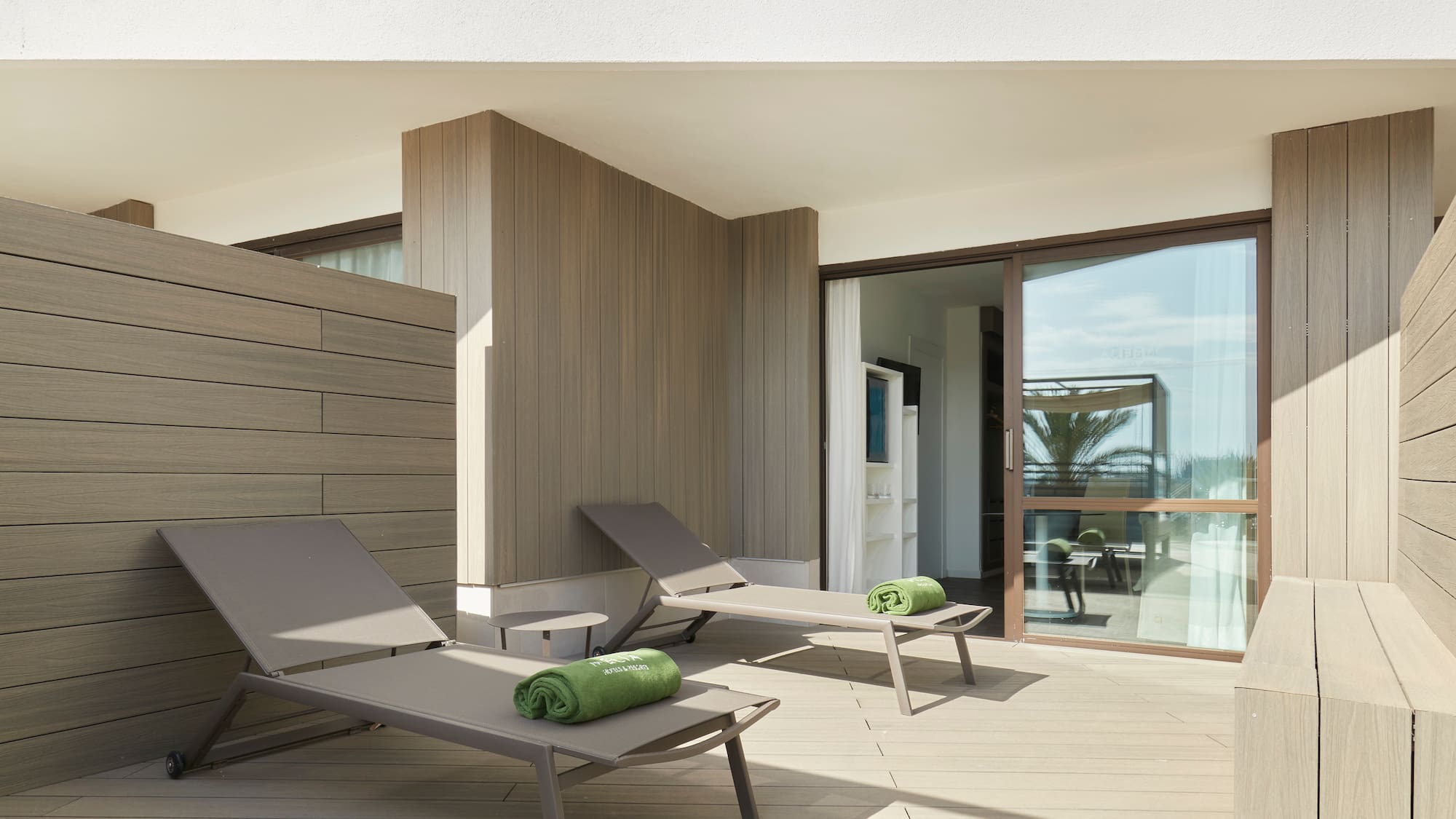 a deck with lounge chairs and towels on it