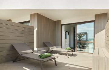 a deck with lounge chairs and towels on it