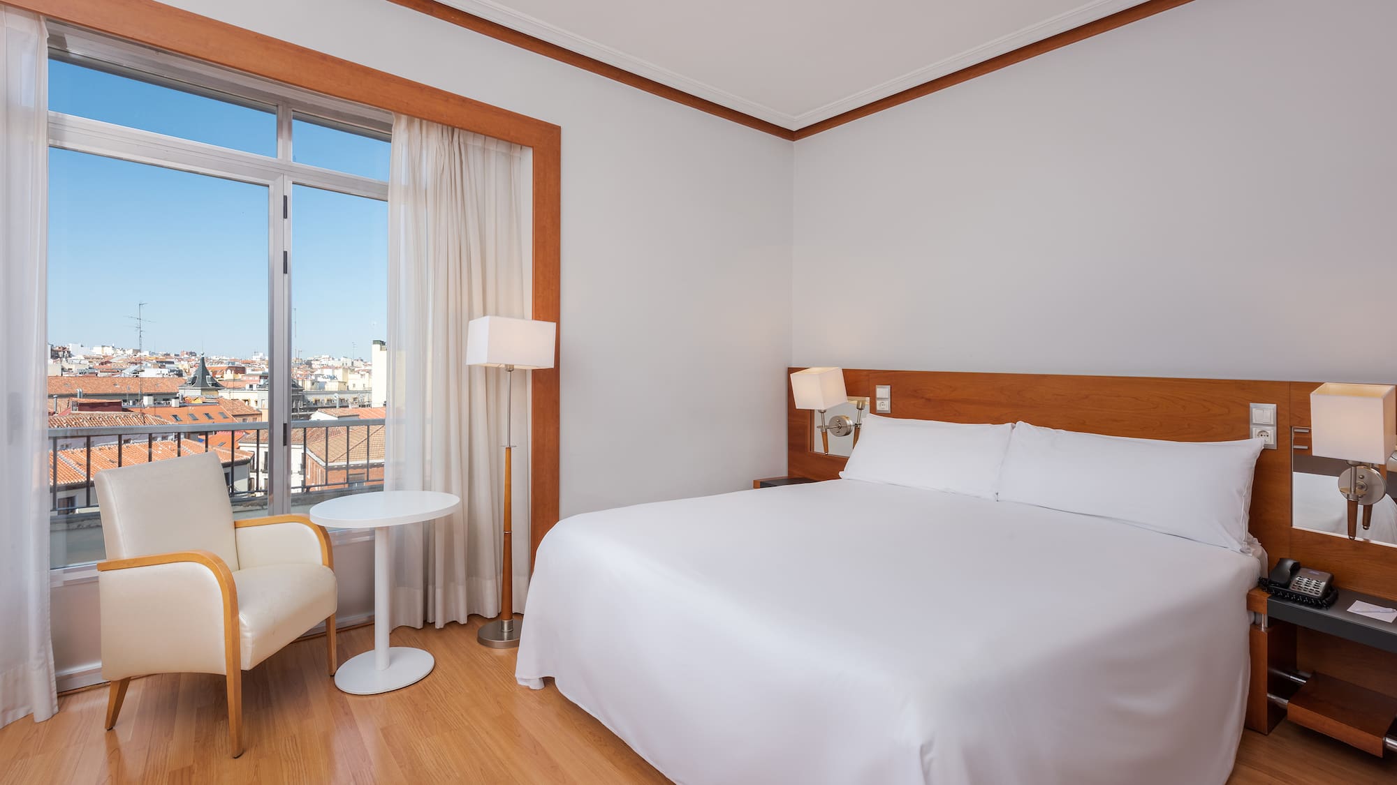 a bedroom with a bed and a chair