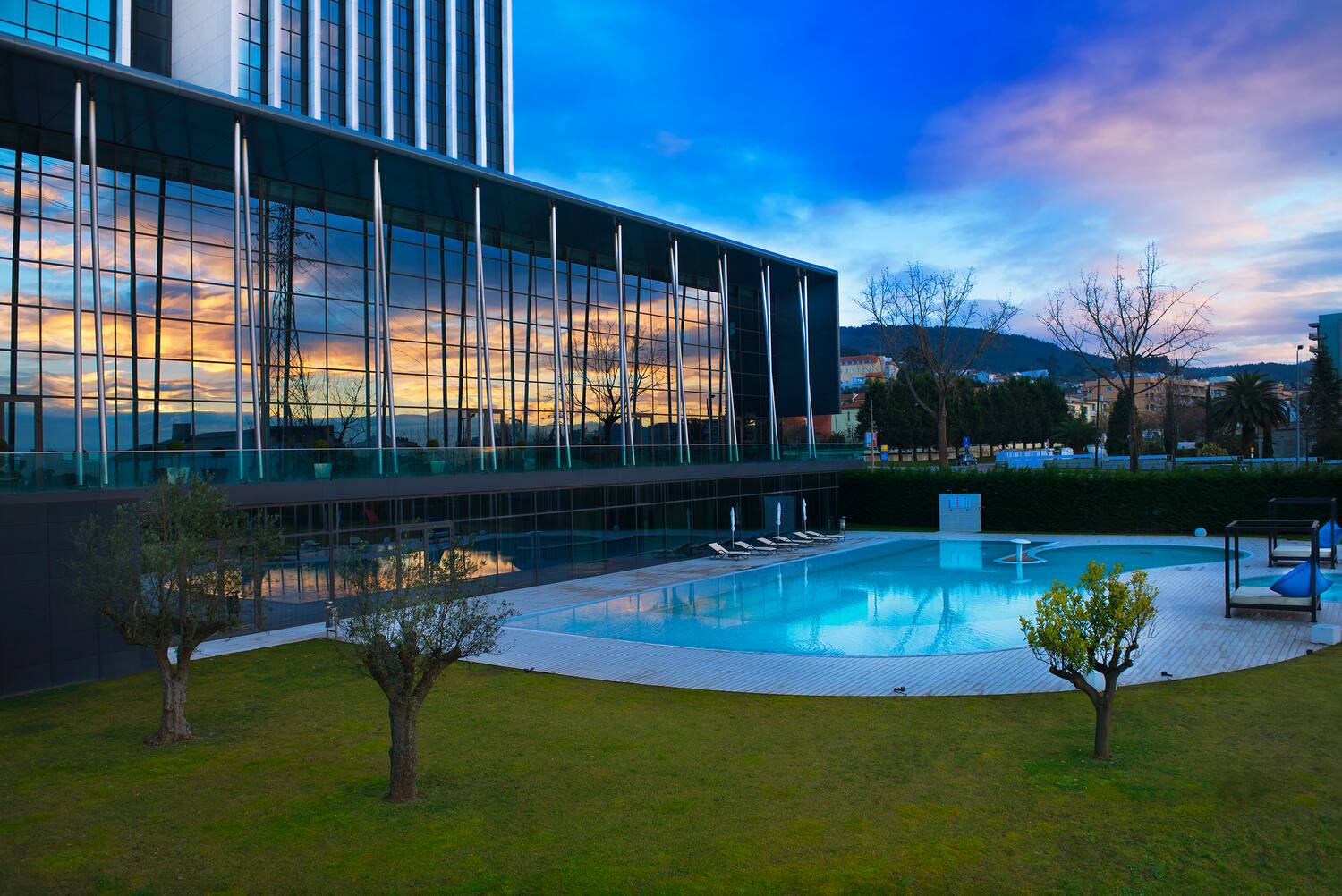 a building with a pool and trees
