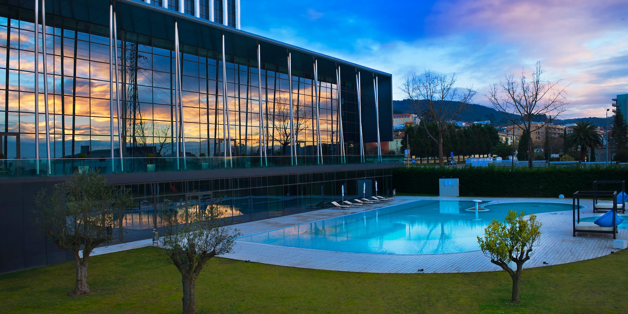 a building with a pool and trees