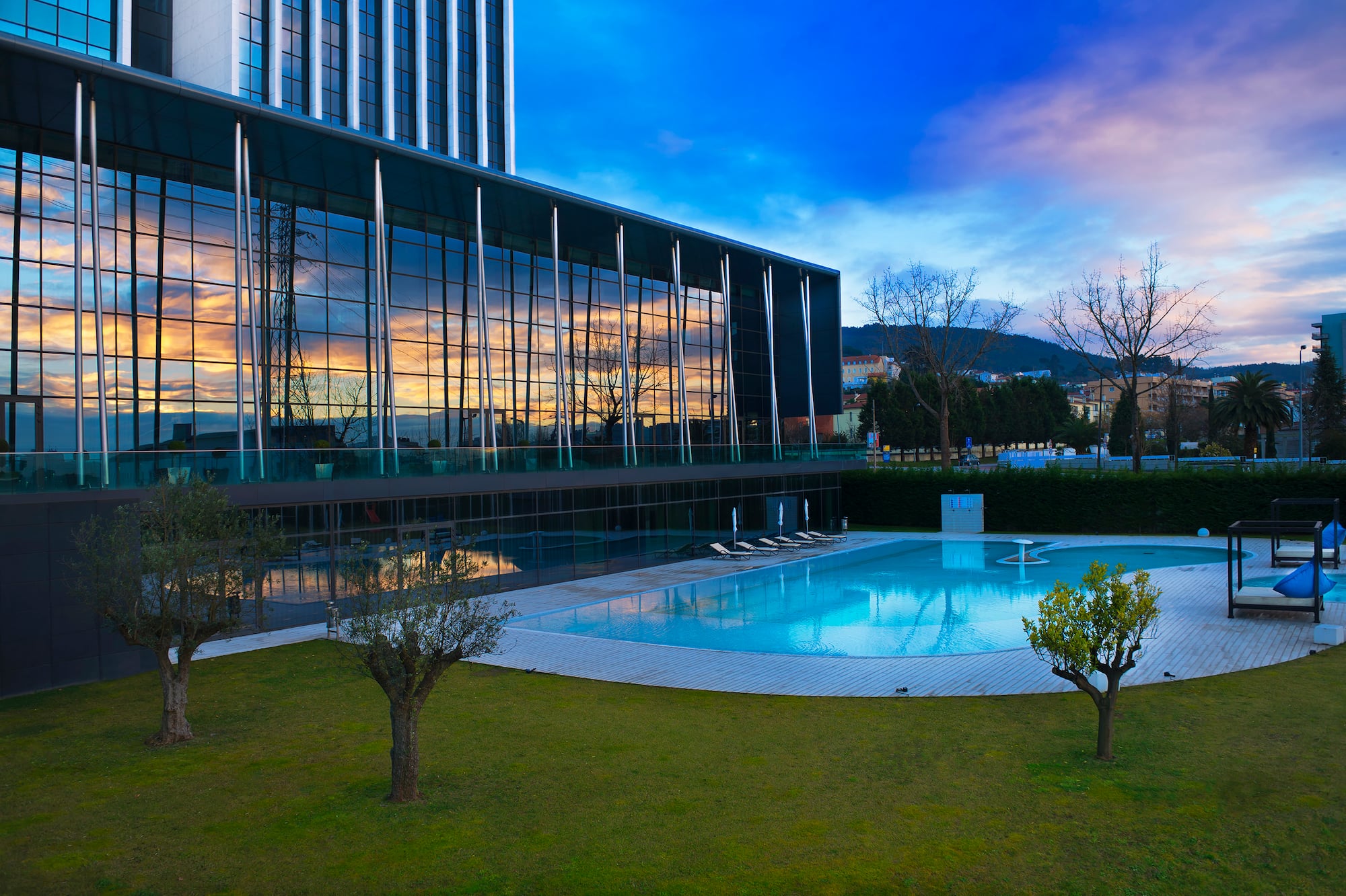 a building with a pool and trees