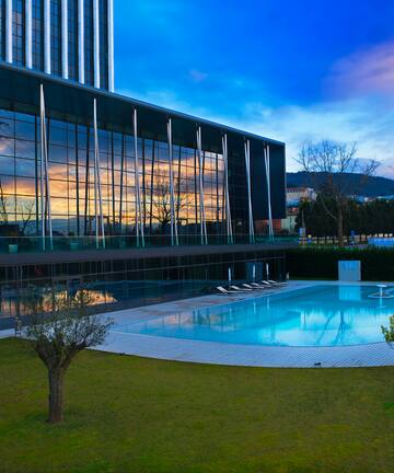 a building with a pool and trees