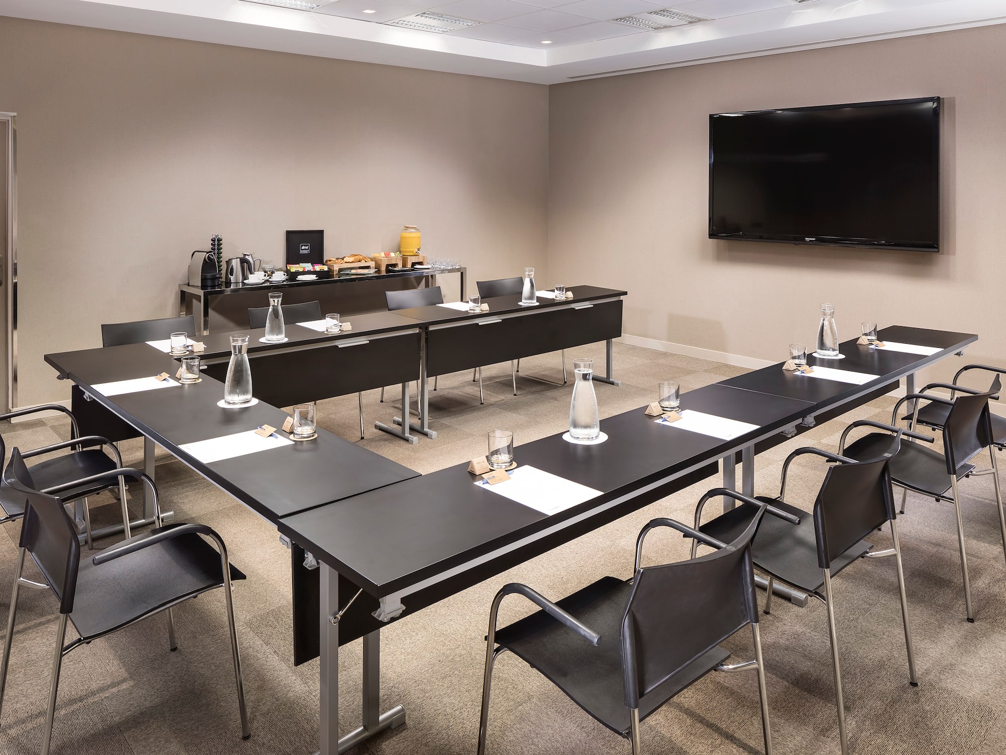 a room with black tables and chairs