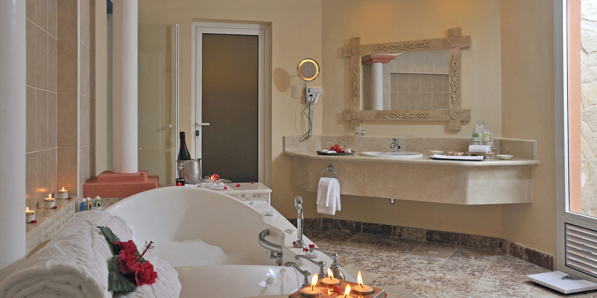 a bathroom with a bathtub and candles