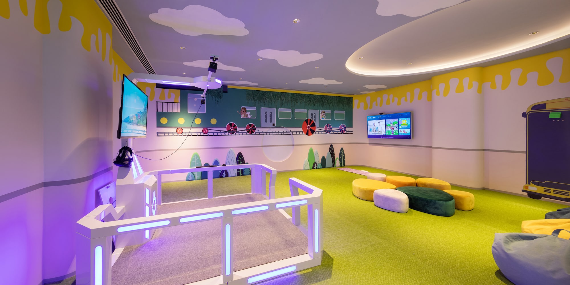 a room with a television and a wall with a train