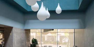 a room with tables and chairs and a blue ceiling