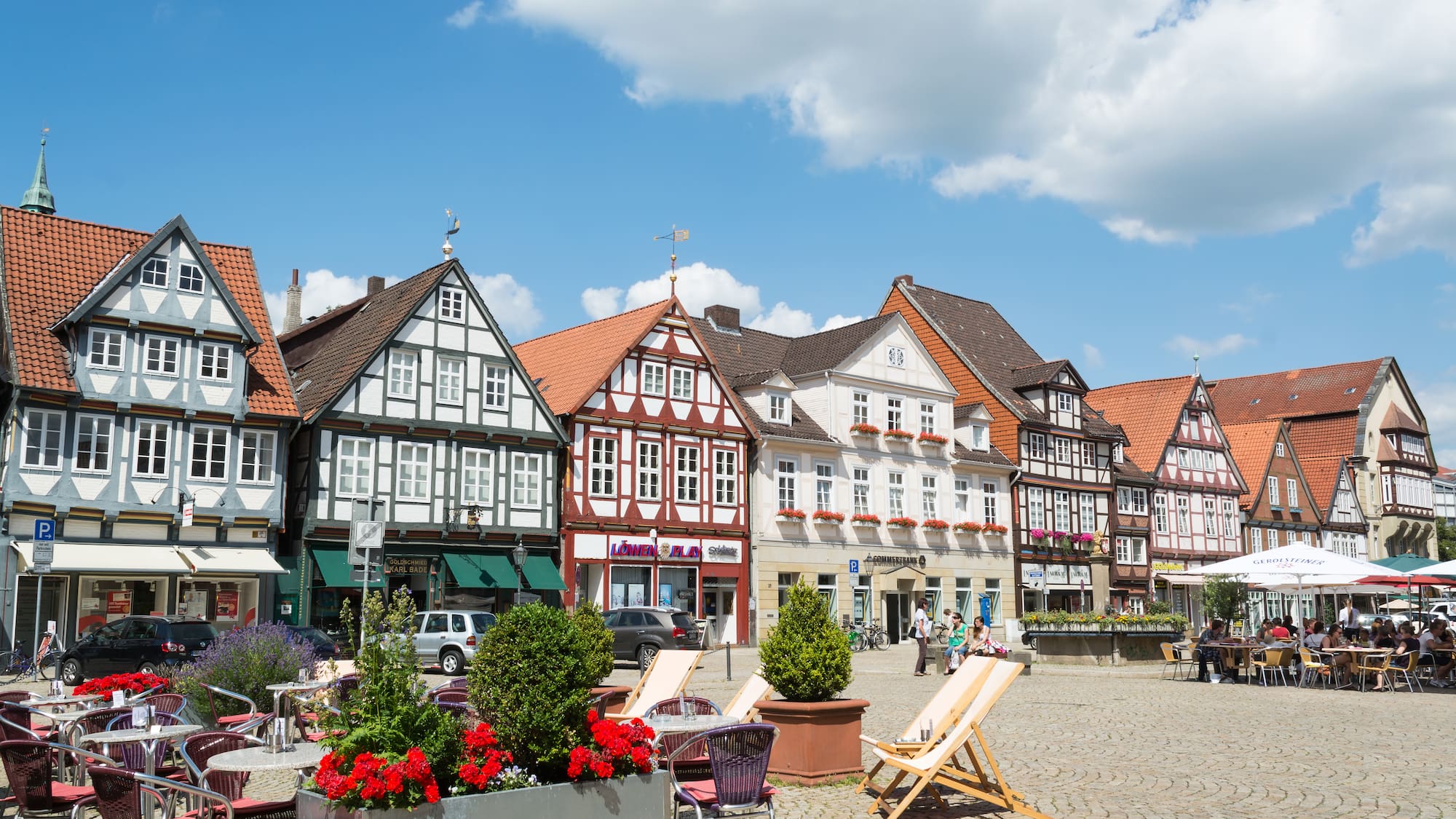 a group of buildings with chairs and flowers