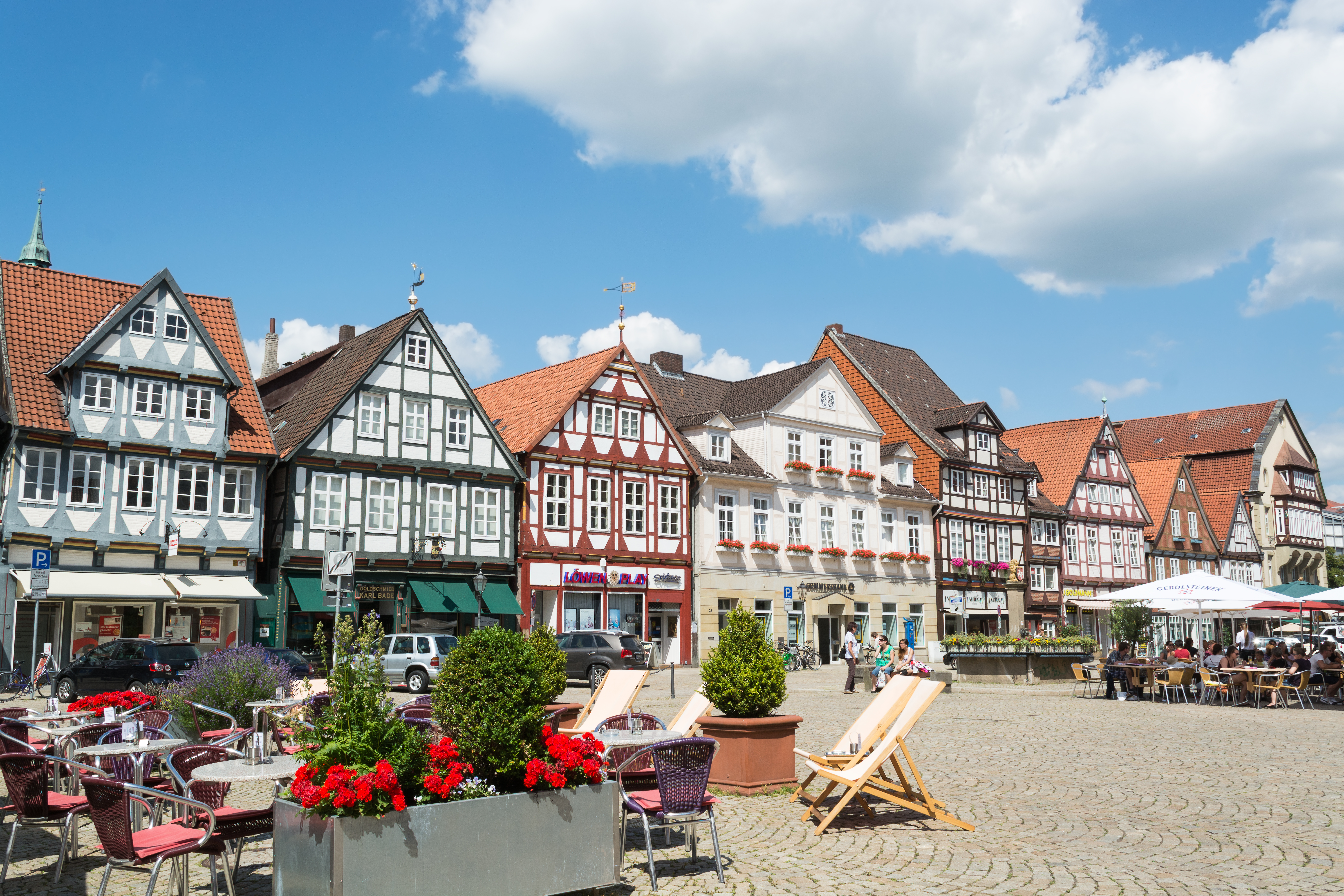 a group of buildings with chairs and flowers