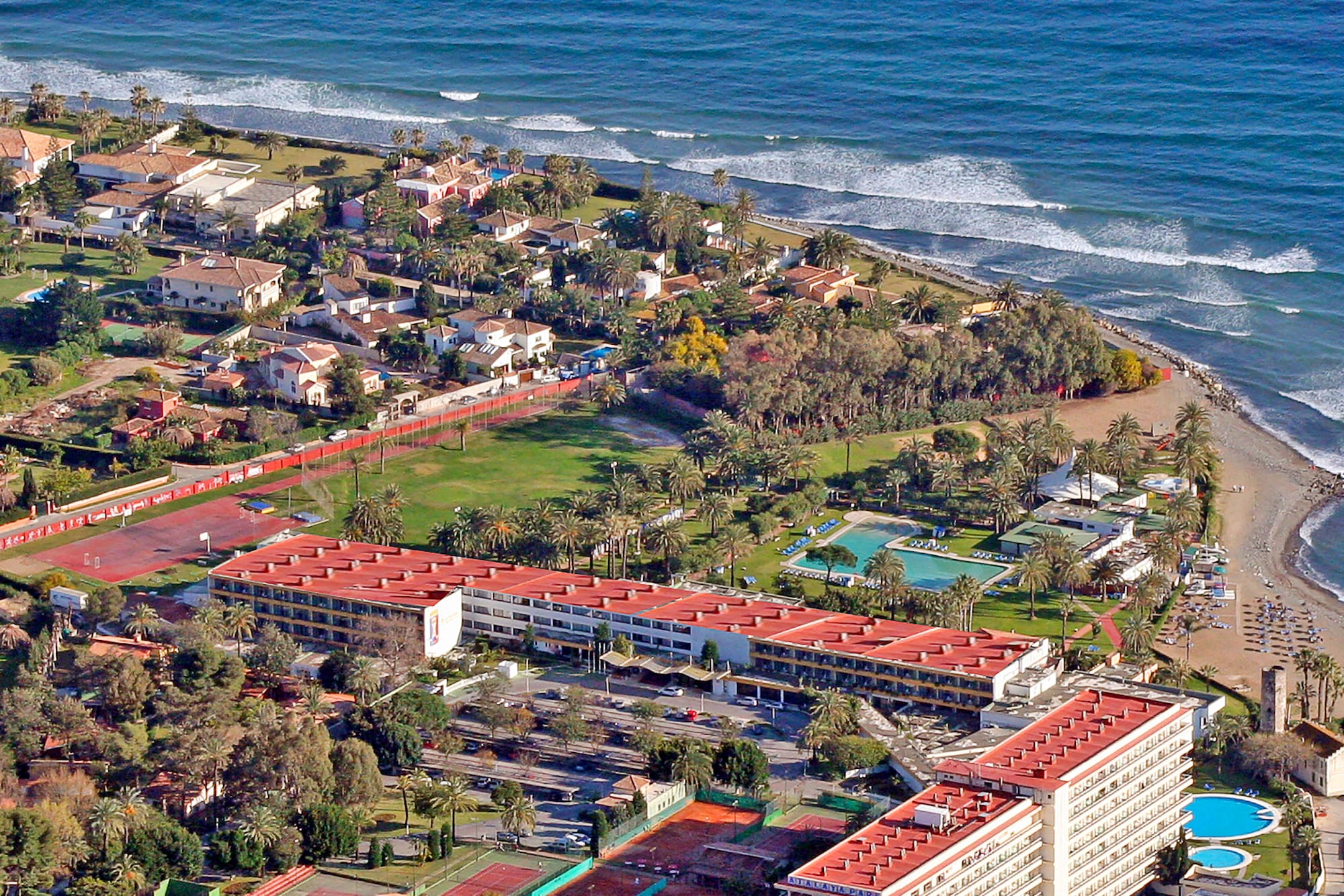 aerial view of a beach with buildings and a pool