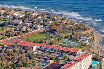 aerial view of a beach with buildings and a pool
