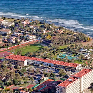 aerial view of a beach with buildings and a pool