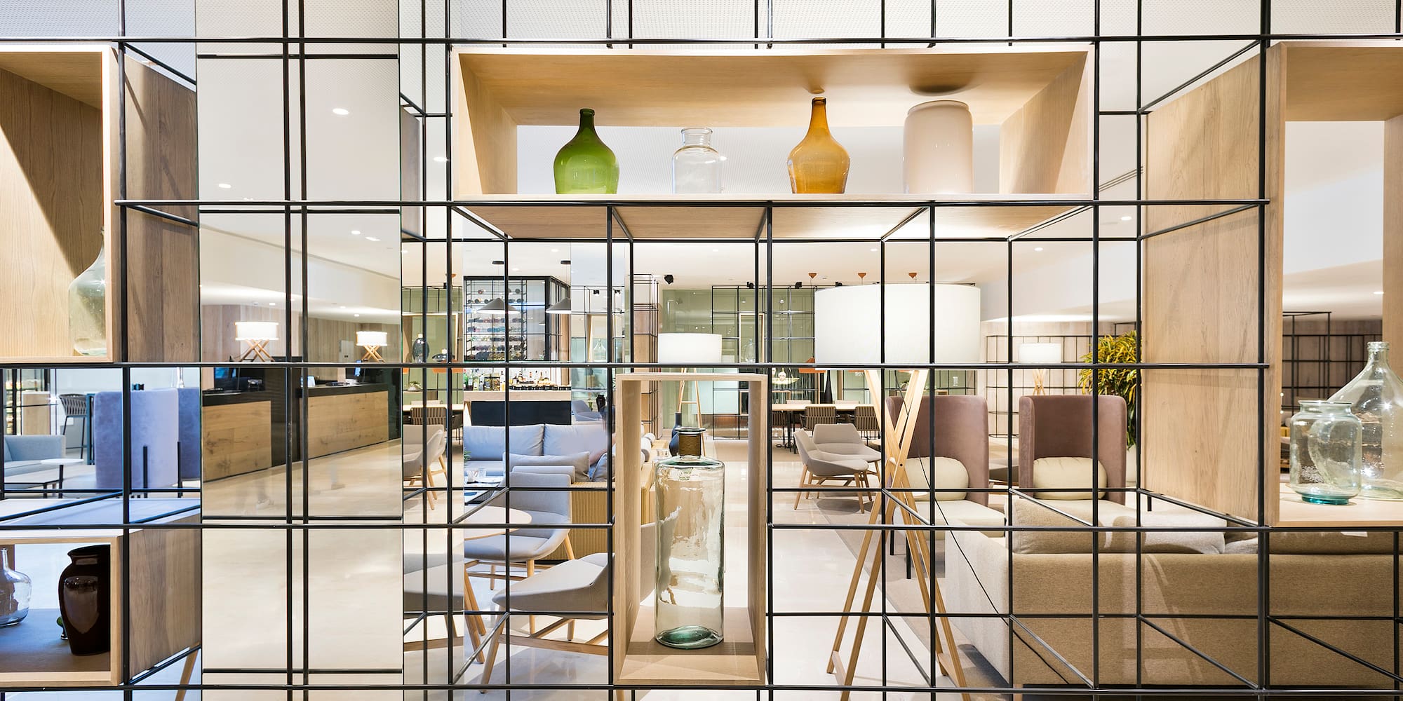 a glass wall with a shelf and a shelf with a chair and a table
