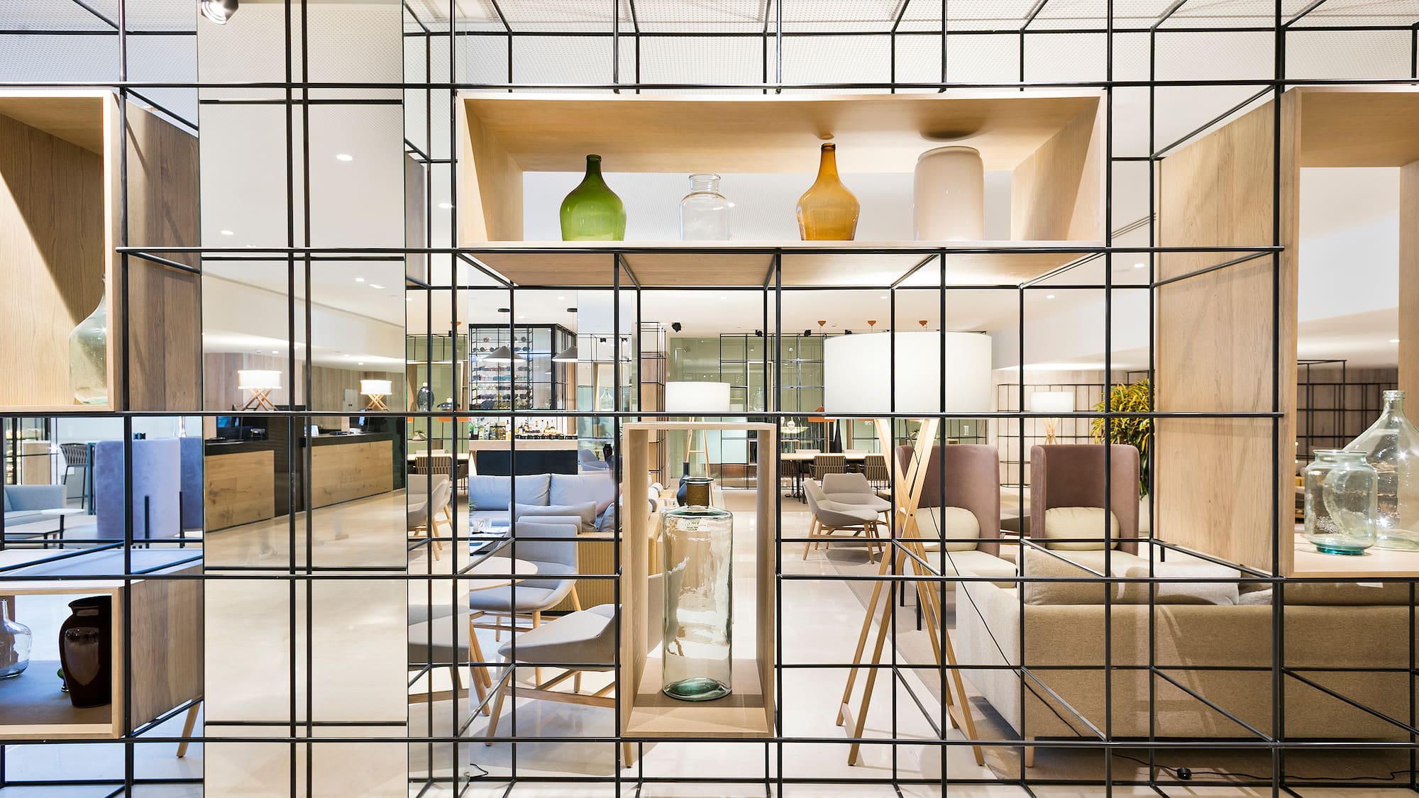 a glass wall with a shelf and a shelf with a chair and a table