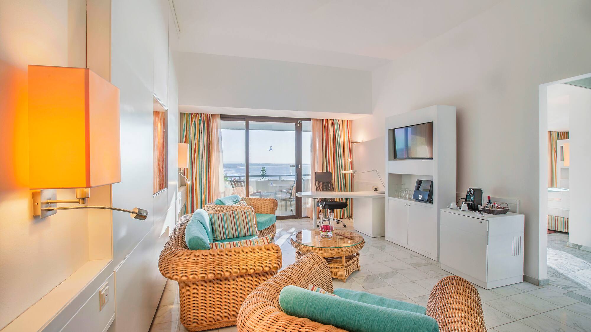 a room with wicker furniture and a television