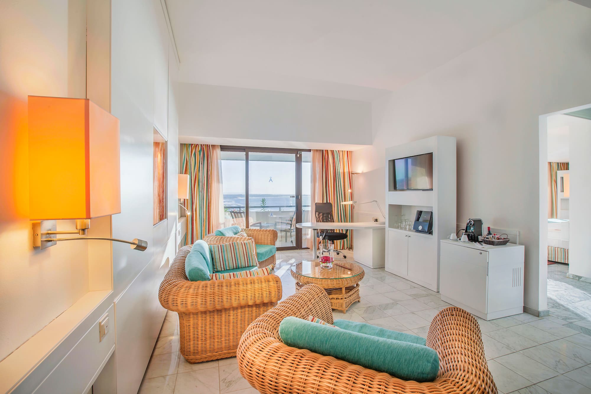 a room with wicker furniture and a television