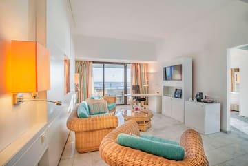 a room with wicker furniture and a television